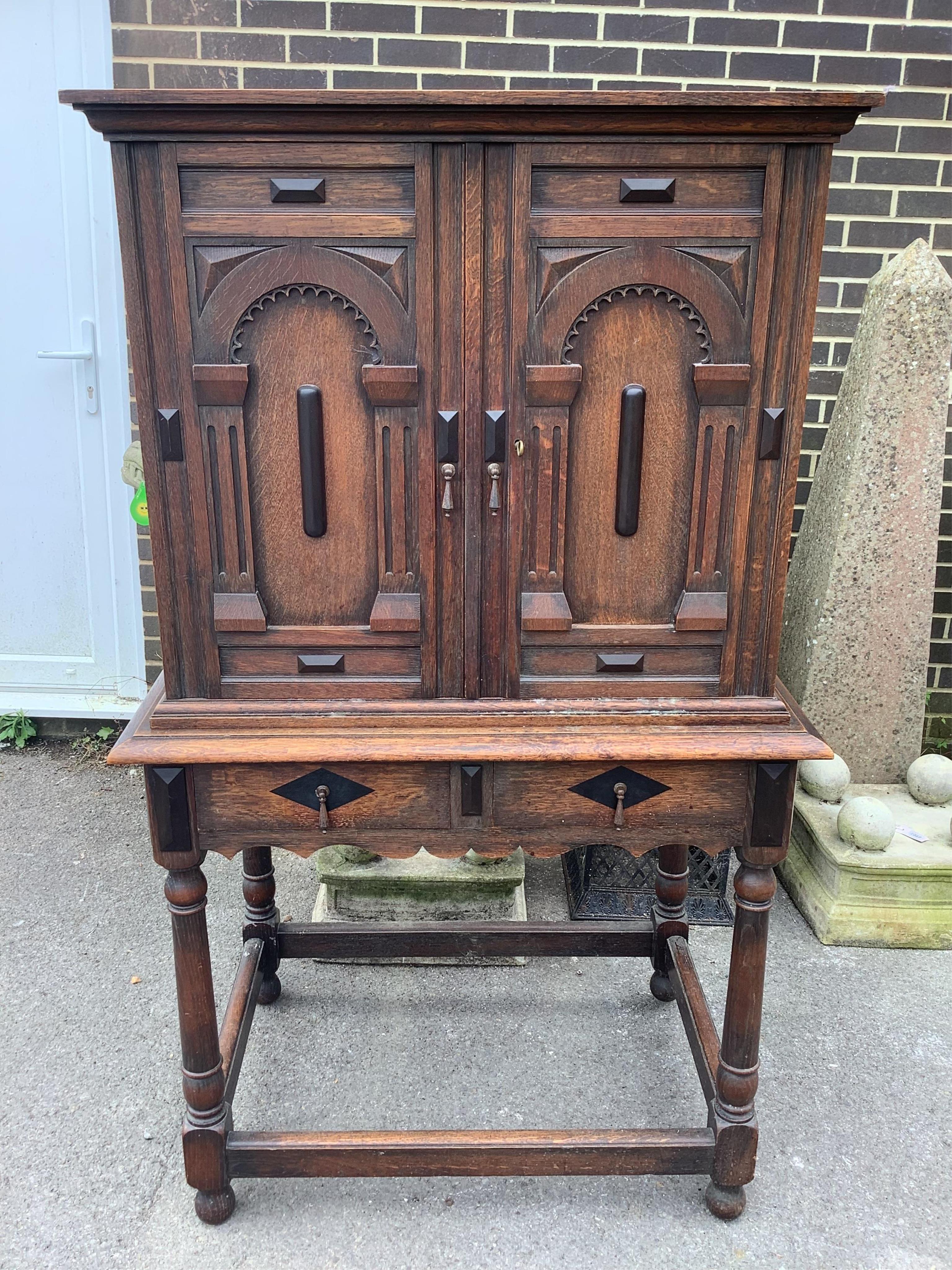 An 18th century style oak cabinet on stand, width 93cm, depth 63cm, height 160cm. Condition - fair
